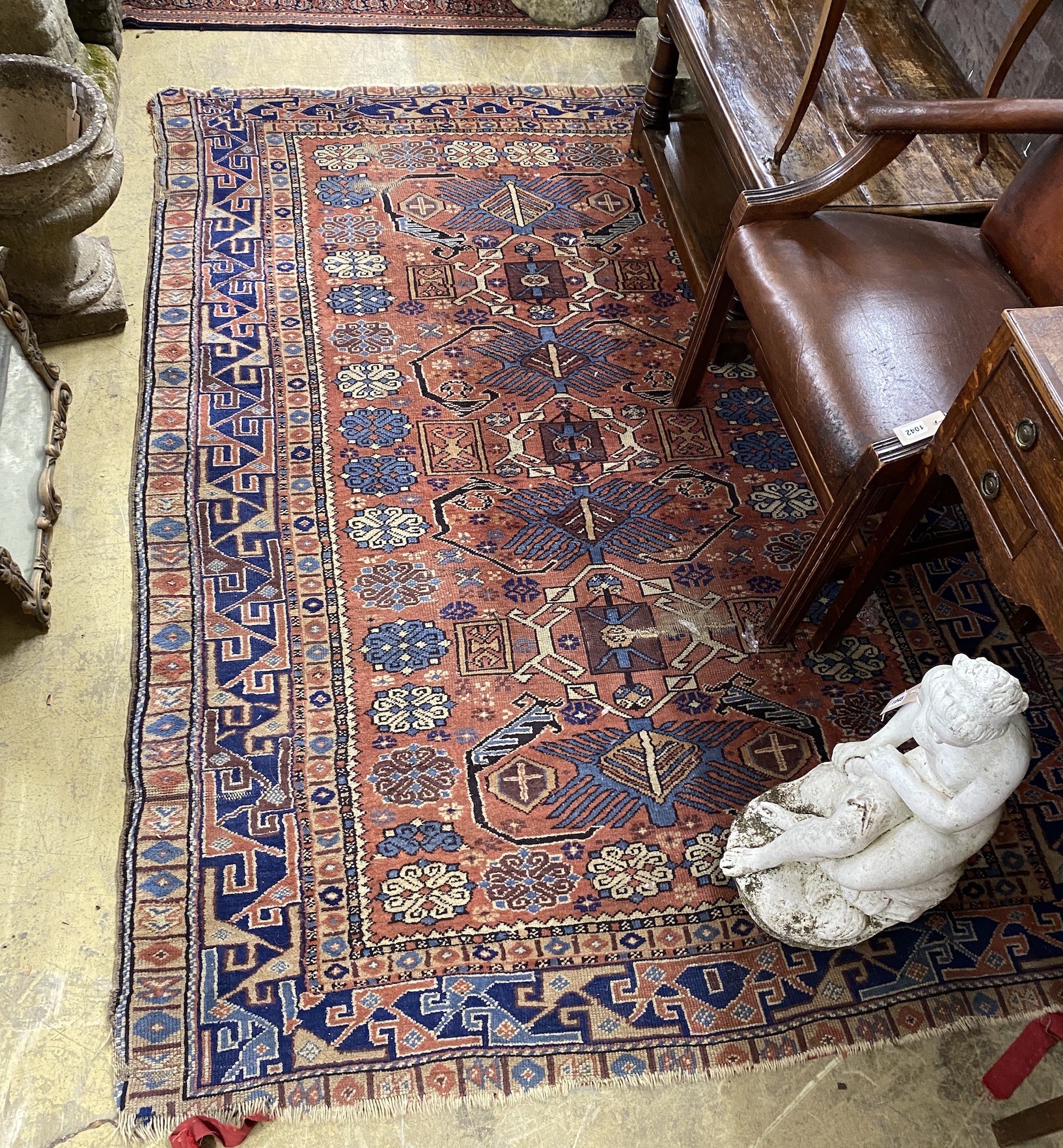 A Shirvan brick red ground rug, 236 x 164cm